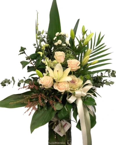 Exquisite Elegance - A delightful vase arrangement that celebrates shades of peaches and cream. Featuring a harmonious blend of fresh blooms, this design is perfect for adding a touch of elegance.