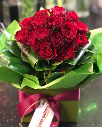 Hearts Desire - A striking bouquet showcasing bold red roses. Presented in a stylish glass vase, this arrangement is designed to make a lasting impression.