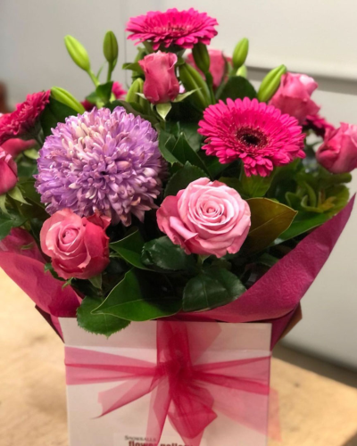 Jada'sCollection - A bold and vibrant collection of pink and purple flowers arranged beautifully in a gift box. Perfect for celebrating special moments or simply brightening someone's day.