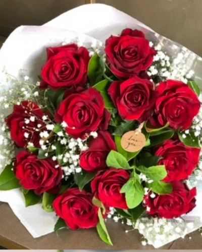 Romance For You - A stunning arrangement of rich red roses complemented by soft green foliage, exuding grace and serenity. This bouquet is perfect for creating a romantic atmosphere in any setting.