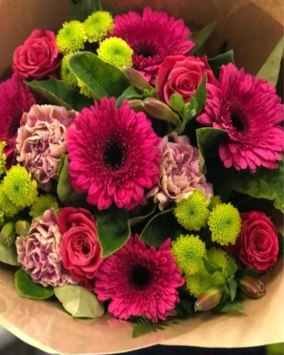 Petite Pink - A charming treat of radiant pink and green flowers, carefully wrapped in natural wrapping. This bouquet is perfect for a thoughtful gesture.