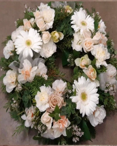 Heartfelt Tribute Wreath - A wreath made with fresh white and cream flowers. This floral arrangement is a beautiful way to express your sympathy and love.