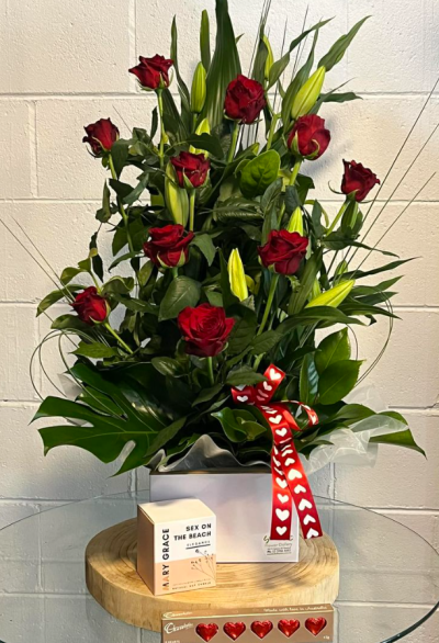 With Love - A romantic gesture that will show the love intended when sending this lily and rose flower arrangement, candle and chocolates.