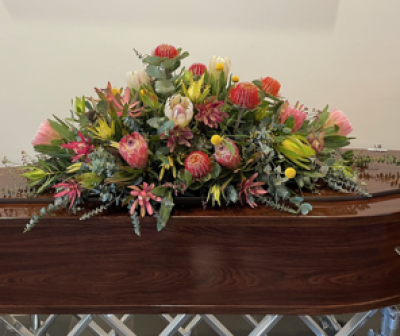 To Sir With Love - A casket tribute for your loved one. native flowers are seasonal so colours may vary than in picture.