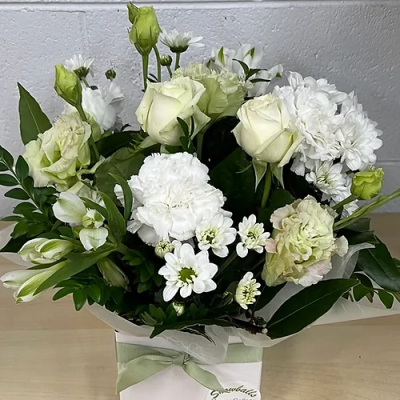 MEMORIES - A boxed arrangement is suitable for a sympathy tribute. Made with seasonal long-lasting blooms.